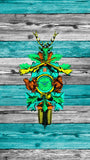Traditional Cuckoo Clock on wooden boards, with green, blue and yellow accents.