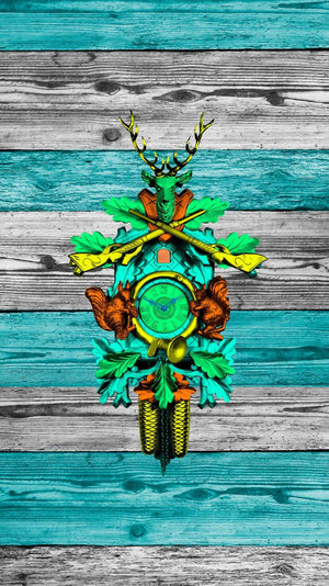 Traditional Cuckoo Clock on wooden boards, with green, blue and yellow accents.