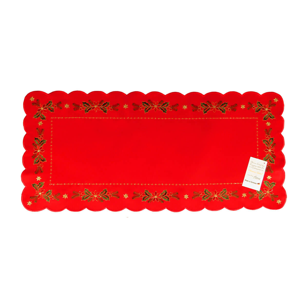 Rectangular red table runner with scalloped edges. The interior border is a line of gold stitching, while the outer border is a pattern of floral arrangements and holly, and a golden star in each corner.
