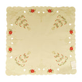Square white tablecloth with Christmas trees in each corner, and a border of cutouts, filigree, and floral arrangemens.