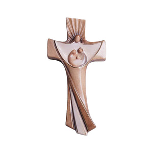 Stylized wooden crucifix of the Holy Family nativity in the center, with a large angel surrounding the middle with a halo of light.