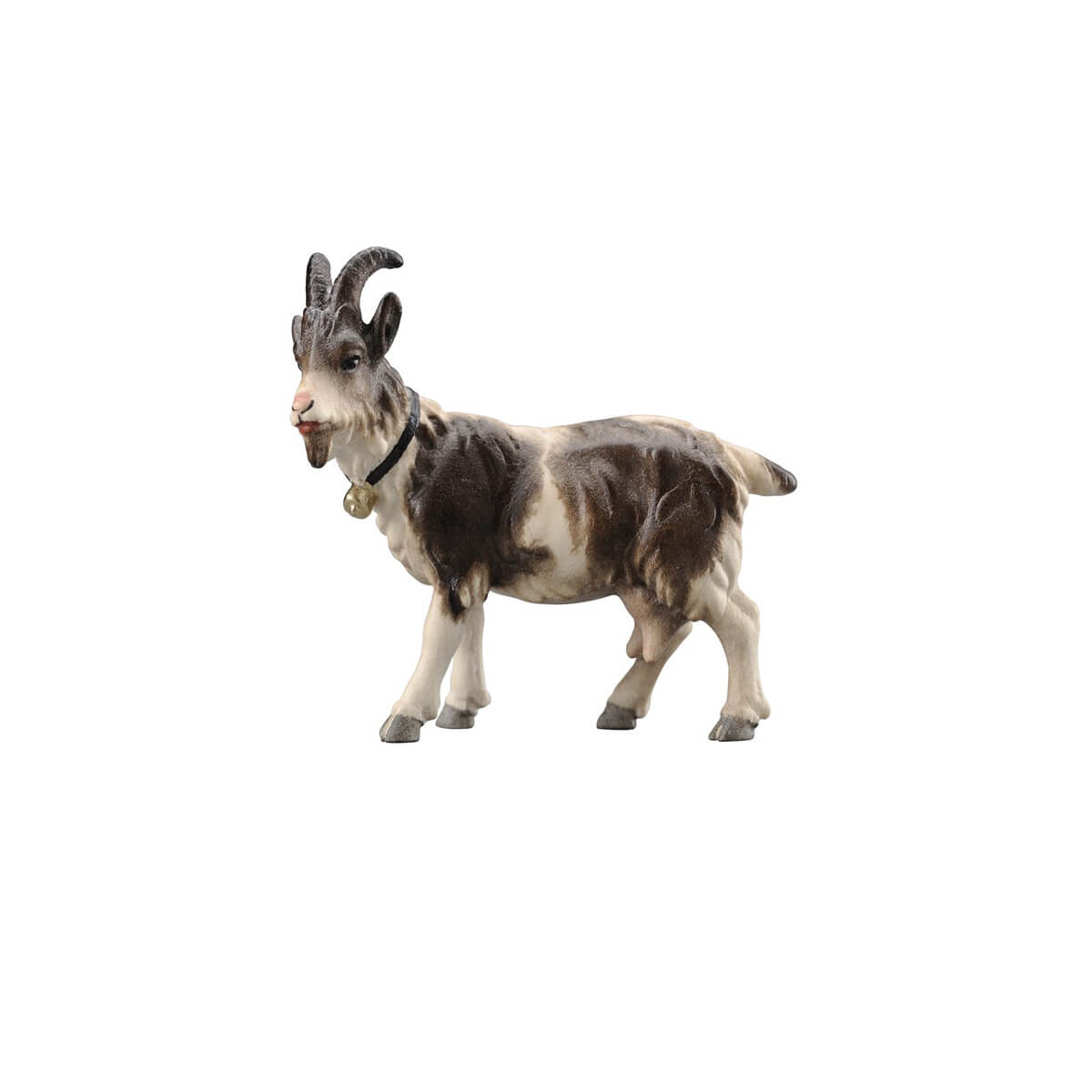 The black and white standing goat is carved out of wood. The goat is looking to the left and is wearing a dark collar with a bell. 