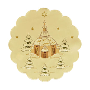 Round cream color table linen with scalloped edges, and a design of a church surrounded by snow covered trees and stars shining above.