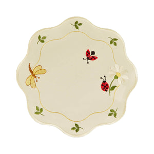 Round white table linen with scalloped edges, and a border design of ladybugs and a dragonfly with a daisy and leaves.