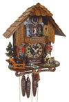 1-Day Schneider Black Forest Chalet Coocoo clock with music. A man is chopping wood on the right side of the platform. On the left, a water wheel spins, and a little brook lined with pebbles on each side is flowing across. There is an evergreen tree and a grazing deer on the left. The clear faced dial shows the sophisticated mechanical movement inside the clock box. Dancers spin on the balcony, above it is the cuckoo clock door underneath the roof with wooden shingles.
