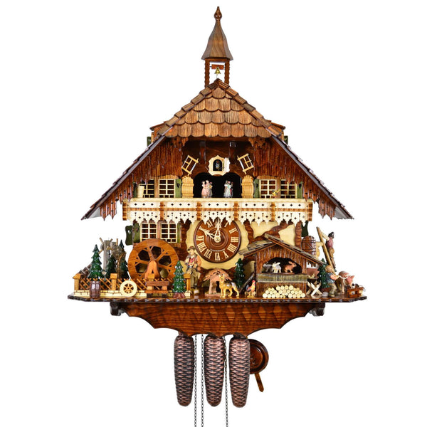 8-Day Chalet August Schwer Black Forest coocoo clock. The solid wood clock features a busy German farmhouse with a steeple on a shingled roof. A water wheel spins by green trees on the left, a farmer is smoking his pipe next to his German shepherd. A hutch houses bunnies spinning around. A rooster stands next to a large pile of logs. Two pigs are on the right and a boy pulls one out of the pen. A farmhand is perched on a ladder on the side. Dancers spin on top of the ornate light balcony.