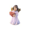 Sculpted wooden Sissi Angel figurine with golden wings in a purple dress, holding a large heart in her hands.