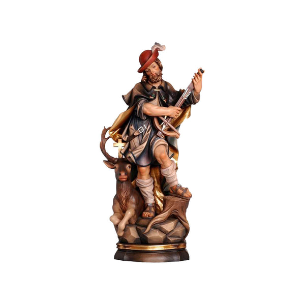 Sculpted wooden statue of St. Hubert in flowing hunting robes and hat, holding a crossbow and arrow, with an elk with a cross between its antlers sitting alongside of him.