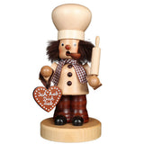 Ulbricht baker smoker (incense burner) in subtle brown shades. With the large chef's hat on his head he stands there in one hand a rolling pin, in the other a gingerbread heart with the words: I love you. 