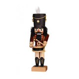 This hand carved Christian Ulbricht Nutcracker is dressed in a marching band drummer attire. His outfit features a large black marching band style hat, a light brown jacket and belt with golden buttons and accents, light brown pants and tall black laced boots. This drummer holds his sticks and his snare drum.