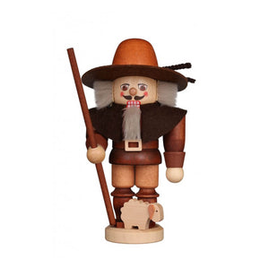 Shepherd nutcracker in natural colors, holding a walking stick, with a small sheep by his feet.