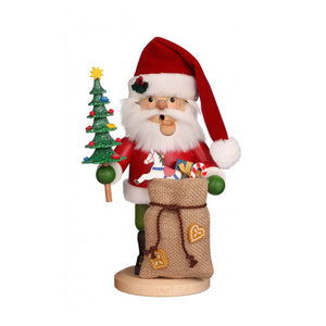 Santa Claus smoker, holding a miniature decorated tree, with a bag full of toys in front of him.
