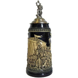 A dark mug with a white relief that shows Leif Erikson with a beer mug in his hand. The stein is completed by the Leif Erikson pewter figure on the pewter lid.
