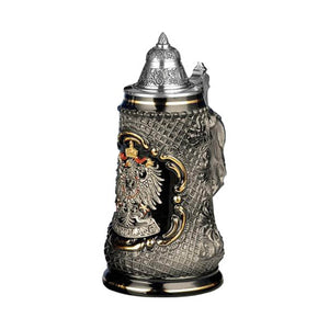 Beer stein with a pewter eagle decorated with gold and red accents, on black background perfectly matches the gray diamond pattern that decorates its sides.